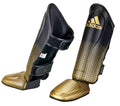 Svarta och guldfärgade Adidas Pro Kickboxing WAKO ben- och vristskydd med anatomisk form och skum i flera lager